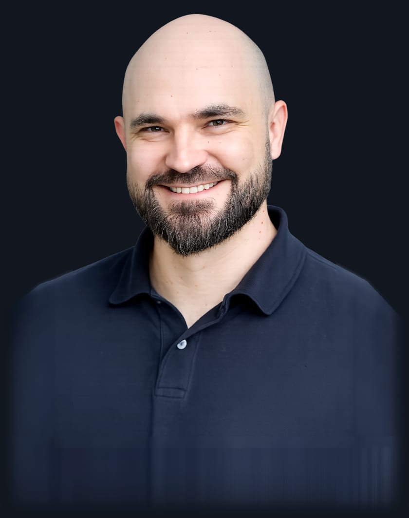 Marcio Prado, photographed against a dark background
